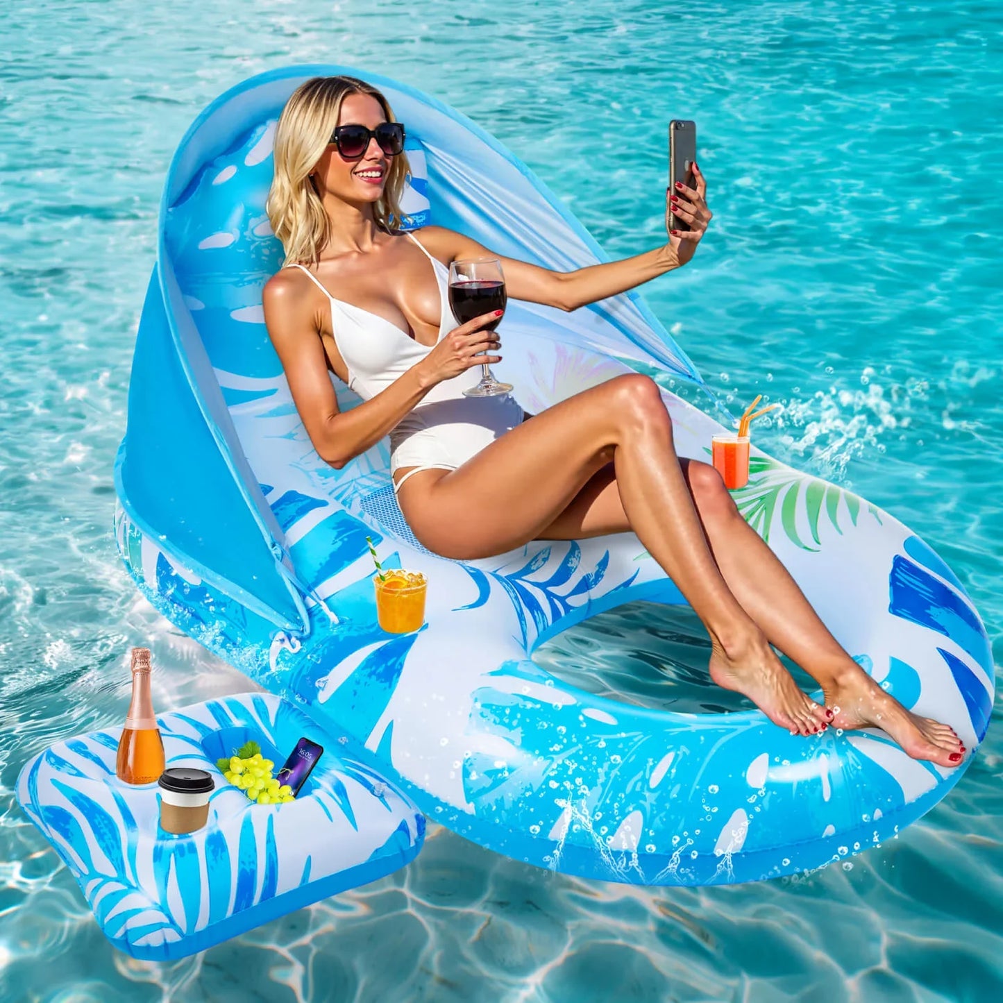 Woman taking a selfie while relaxing on a luxurious inflatable pool lounger float with a sun canopy and a glass of wine.