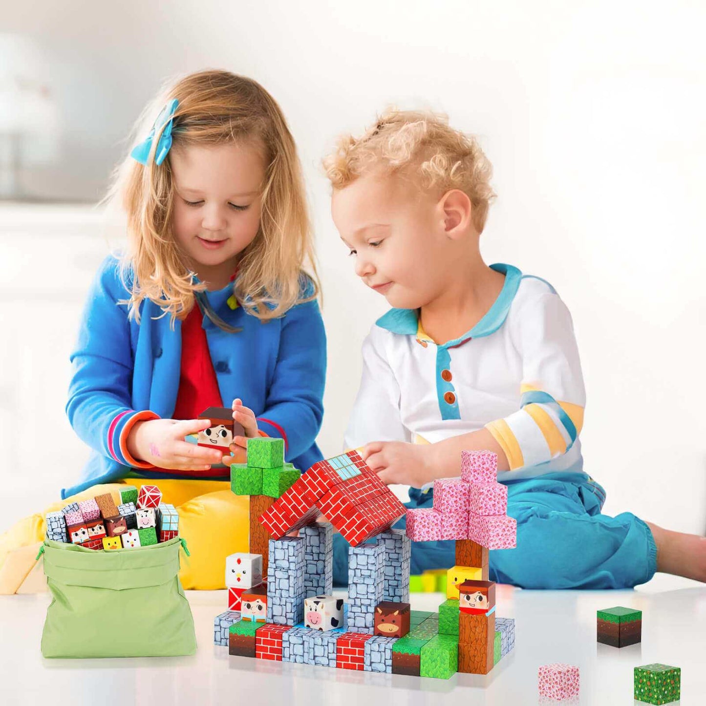 Two children are building a ranch with magnetic building blocks