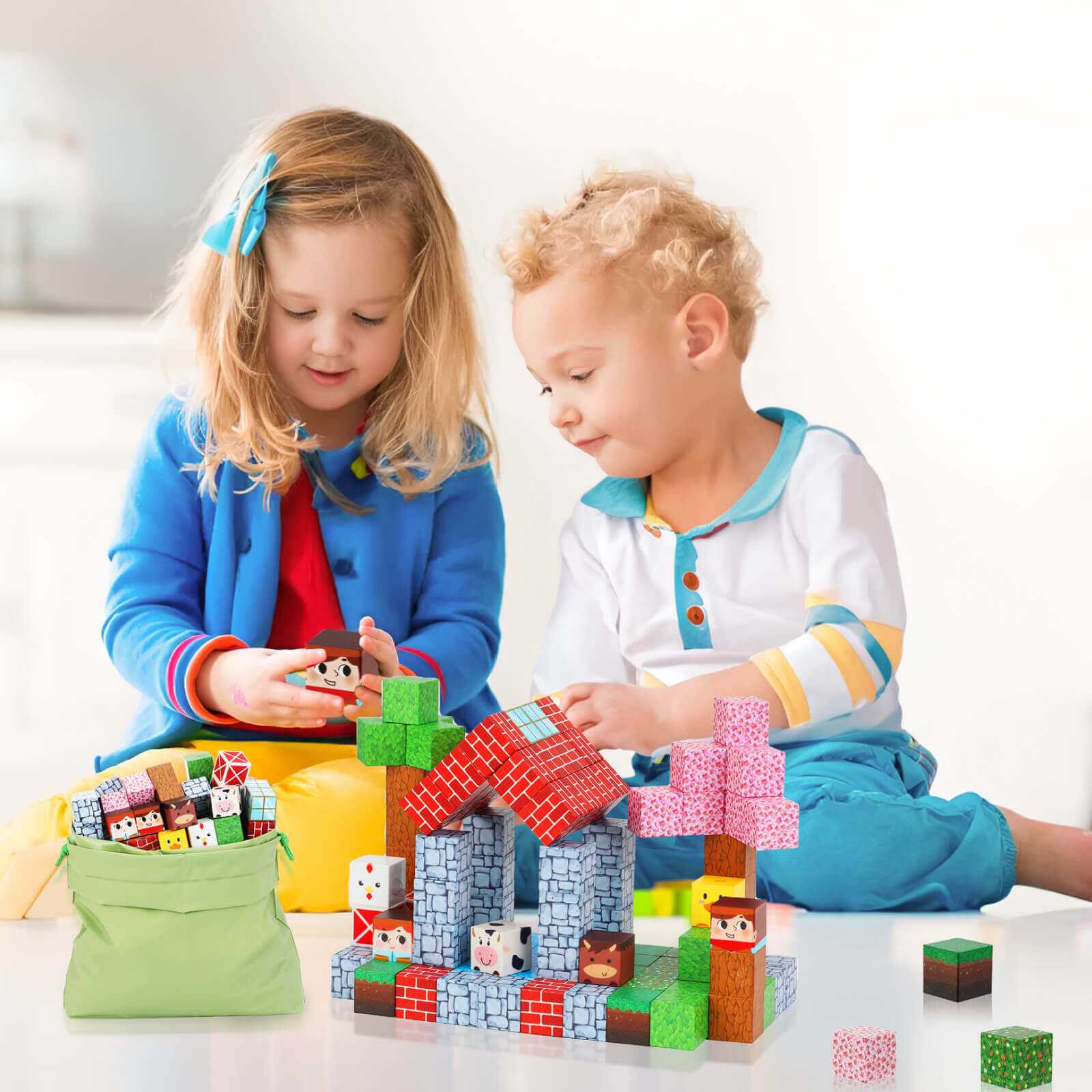 Two children are building a ranch with magnetic building blocks